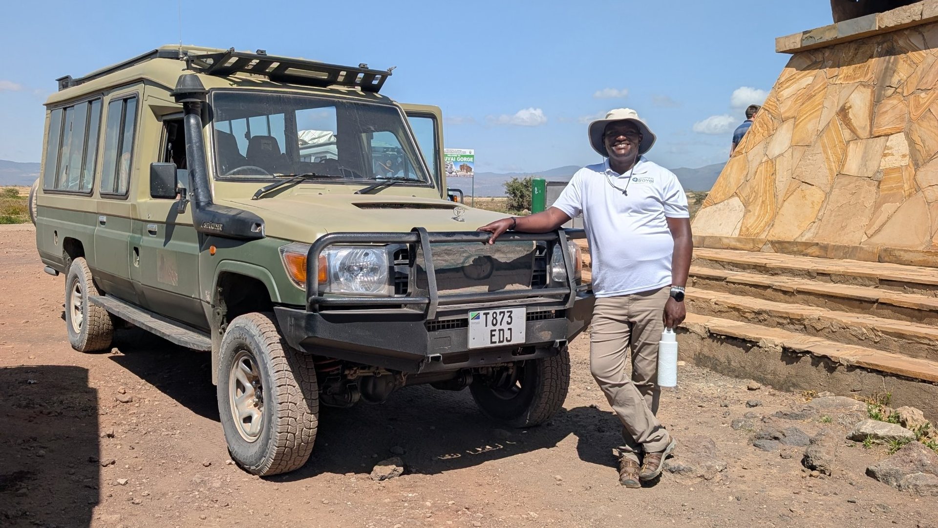 Accessible Travel guide with a safari vehicle near Olduvai Gorge
